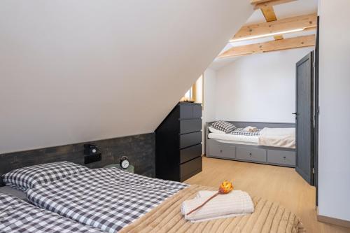 a bedroom with two twin beds and a loft at Chata Jarabina in Terchová