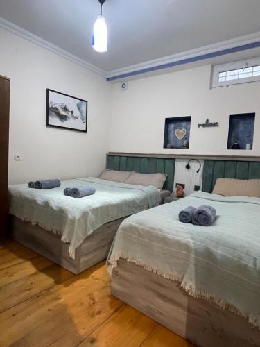 a bedroom with two beds with towels on them at Autøgráph Boutique Høme 9 in Borjomi