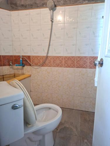 a bathroom with a toilet with the lid up at Budget Place Homestay-Solo Traveler in Ban Dan
