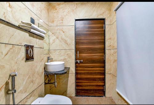 a bathroom with a toilet and a sink at Hotel Dosa plaza in Udaipur