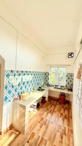 a kitchen with a table in the middle of a room at Serenyaa in Dibrugarh