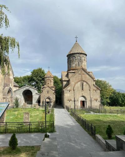 an old stone church with a cross on top of it at Mon Ami Tsaghkadzor in Tsaghkadzor