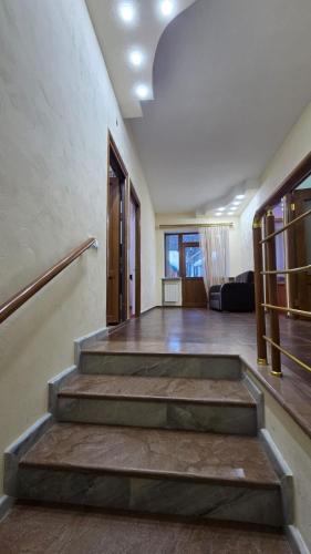 a room with stairs and a living room at Mon Ami Tsaghkadzor in Tsaghkadzor