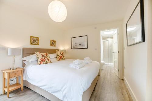 a bedroom with a large white bed with towels on it at 3 Bed in Bamburgh oc-w31886 in Bamburgh