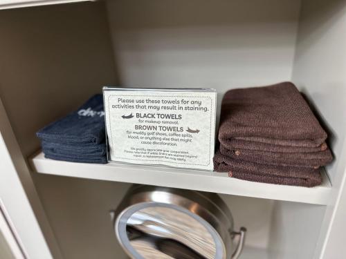 a shelf with towels and a box on it at Resort at Eagle Point Golf Club Lodging in Medford