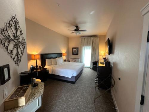 a hotel room with a bed and a television at Resort at Eagle Point Golf Club Lodging in Medford