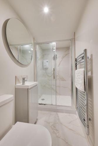 a bathroom with a shower and a toilet and a mirror at 2 Bed in Holt oc-2195 in Holt