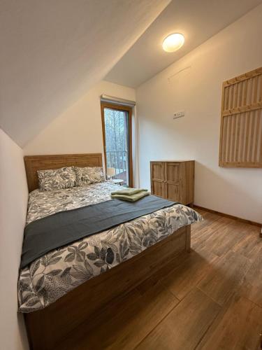 a bedroom with a large bed in a room at Forest House Buxusson in Dolní Slověnice