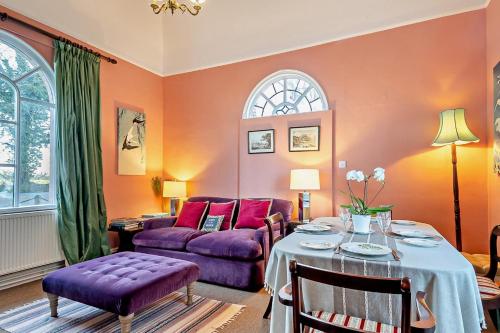 a living room with a table and a purple couch at 1 Bed in Wymondham oc-w30597 in Wymondham