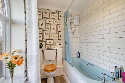 a bathroom with a toilet and a bath tub at 1 Bed in Wymondham oc-w30597 in Wymondham
