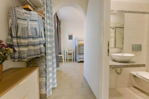 a bathroom with a sink and a toilet in a room at Victoria Studios & Apartments in Mikri Vigla