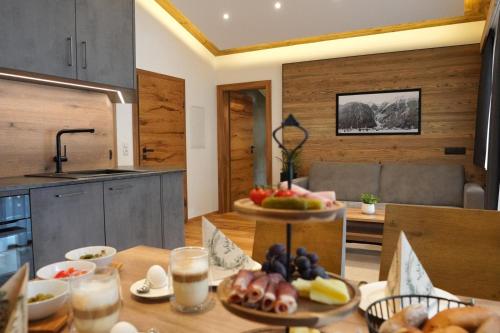 a kitchen with a table with a bowl of fruit on it at Alpenapart Schmid in Niederthai