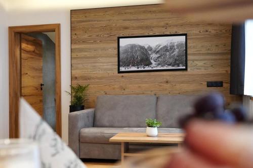 a living room with a couch and a table at Alpenapart Schmid in Niederthai