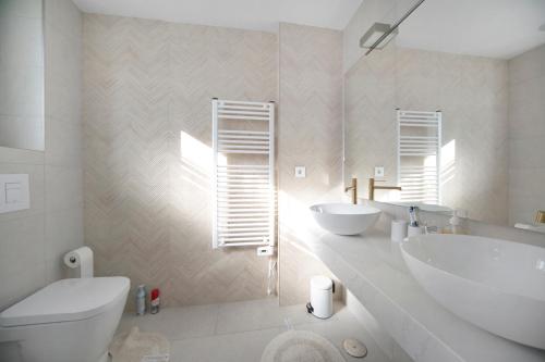 a bathroom with a tub and a sink and a toilet at Calpe Silver Tower 5B in Calpe