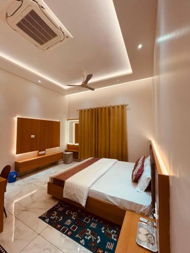 a bedroom with a bed and a ceiling fan at Shree Shivay Homestay in Sathri
