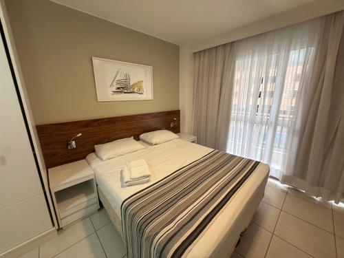 a hotel room with a bed and a window at Vision Hotel - Flat Particular in Brasília
