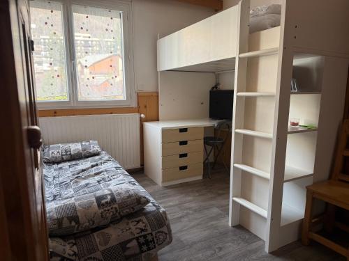 a bedroom with a bunk bed and a desk at Location studio à Serre Chevalier 1350 in Saint-Chaffrey