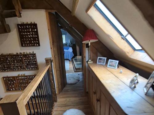 a attic room with a wooden counter and windows at The Old Mill Annexe in Jacobstowe