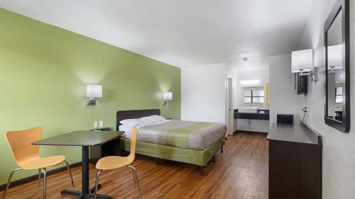 a hotel room with a bed and a table and chairs at Motel 6 Chattanooga, TN in Silverdale