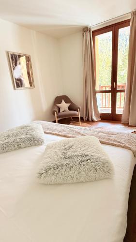 a bedroom with two beds and a window at Maison Poluc - Chiaro di Luna in Champoluc