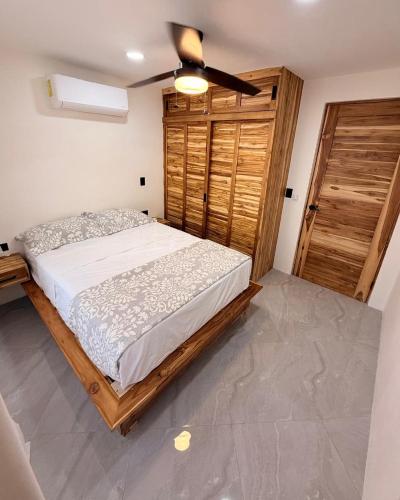 a bedroom with a bed and a ceiling fan at Brianne's Place in Playa hermosa