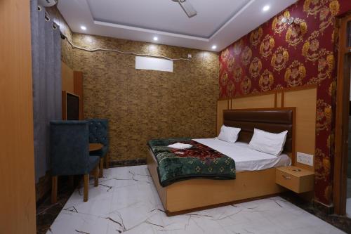 a bedroom with a bed and a chair in a room at New Awadhesh Singh Hotel in Chauri