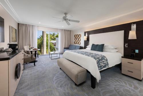 a bedroom with a large bed and a bathroom at The Palms Hotel & Spa in Miami Beach