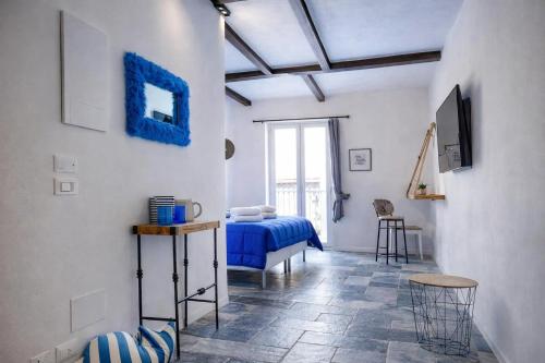 a bedroom with a bed and a television in it at Hotiday Polignano Centro - Fico d'India in Polignano a Mare