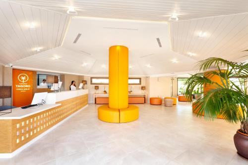 an office with a yellow column in the middle of a lobby at Tagoro Family & Fun Costa Adeje in Adeje