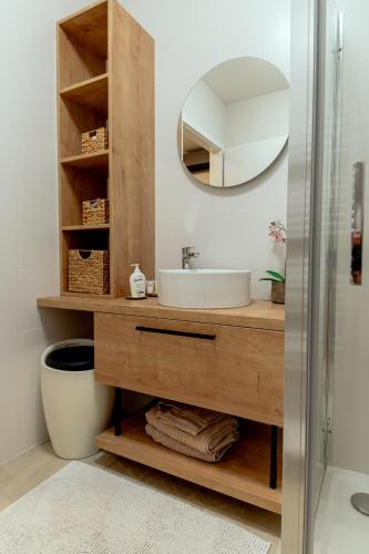 a bathroom with a sink and a mirror at Anur Apartment in Ptuj