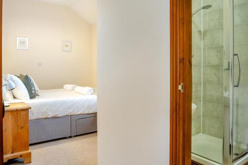 a bedroom with a bed and a glass shower at 3 Bed in Whitwell oc-h33498 in Whitwell