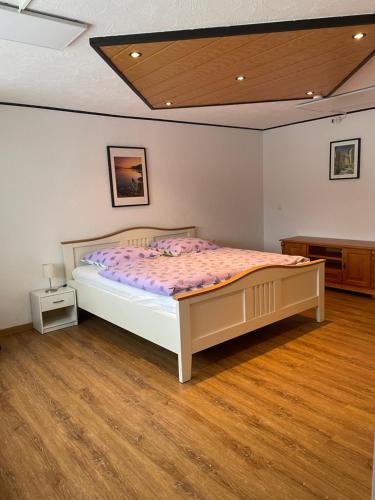 a bedroom with a bed and a wooden floor at Zum Talblick in Limbach