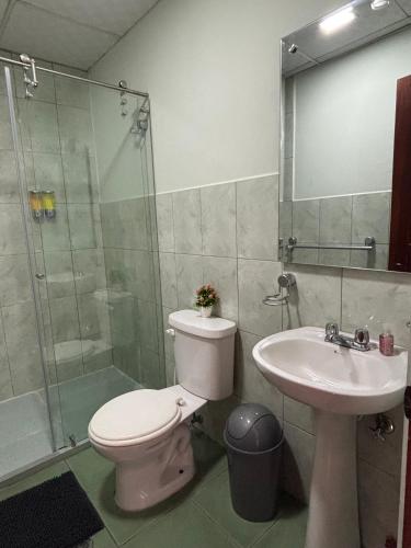 a bathroom with a toilet and a sink and a shower at Casa La Ronda in Quito