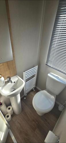 a bathroom with a white toilet and a sink at Graham's Dream in Heysham