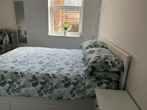 a bed in a bedroom with a window at Flat 2 Frank Lewis House in Hay-on-Wye