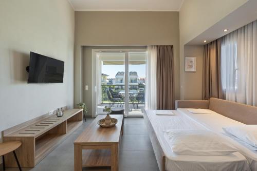 a bedroom with a large bed and a large window at Bianco Mare Studios-Apartments in Kalives Poligirou