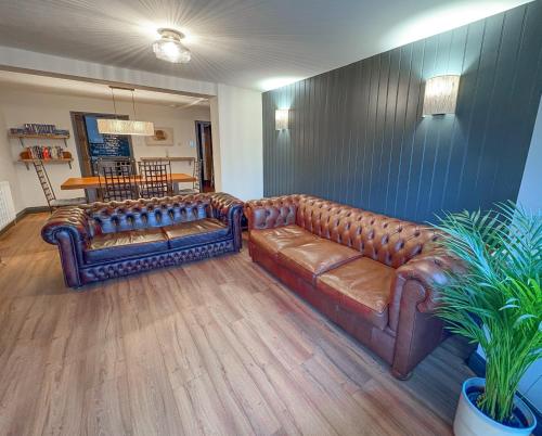 a living room with a leather couch and a table at 4 Bed Home In Central Maldon in Maldon