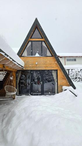 a house with snow in front of it at Tana dell Lupo in Colibiţa
