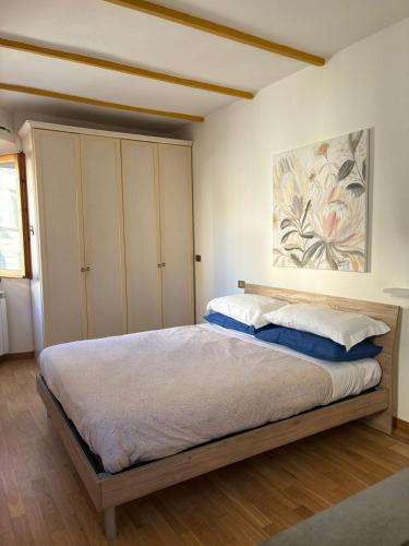 a bedroom with a bed and a painting on the wall at Lovely Stay in Sesto Fiorentino