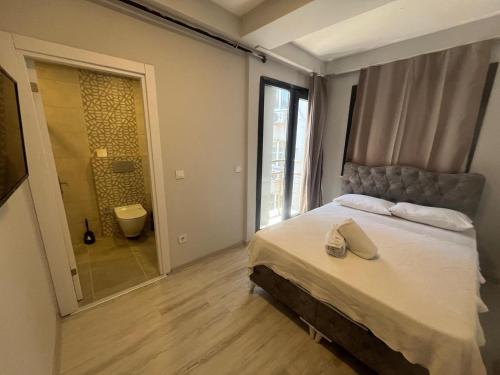a bedroom with a bed and a bathroom with a shower at Kadıköy Miski Amber in Istanbul