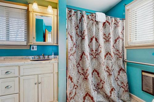 a bathroom with a shower curtain and a sink at Live Laugh Lake - A in Rushville