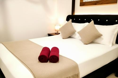 a bedroom with a bed with red slippers on it at Yala Eagle Nest & Safari in Tissamaharama