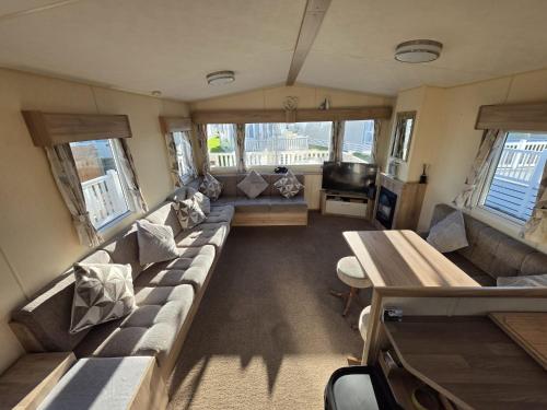 a living room with a couch and a table at Chichester Lakeside holiday park in Merston