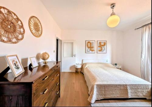 a bedroom with a large bed and a wooden dresser at Rooftop Carcente in San Siro