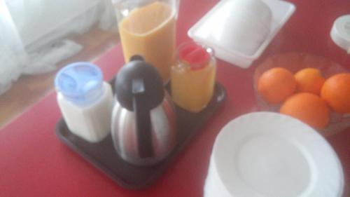 a table with a blender with milk and eggs and oranges at Hotel Plaza Miami - Sólo Adultos in Miami Platja