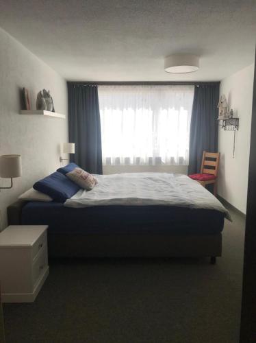 a bedroom with a large bed and a window at Hotel Europe App 303 in Davos