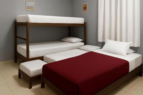 a room with two bunk beds and a stool at Quarto - Room Econômico da Maricotinha - No Air Cond in Manaus