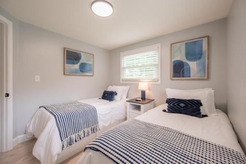 a bedroom with two beds and a window at Modern Home 2 Miles to Virginia Tech in Blacksburg
