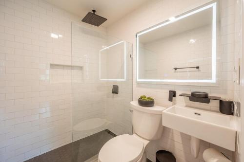 a white bathroom with a toilet and a sink at Modern Home 2 Miles to Virginia Tech in Blacksburg