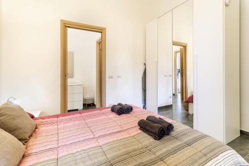 a bedroom with a large bed with two towels on it at Malpensa sweet home in Busto Arsizio
